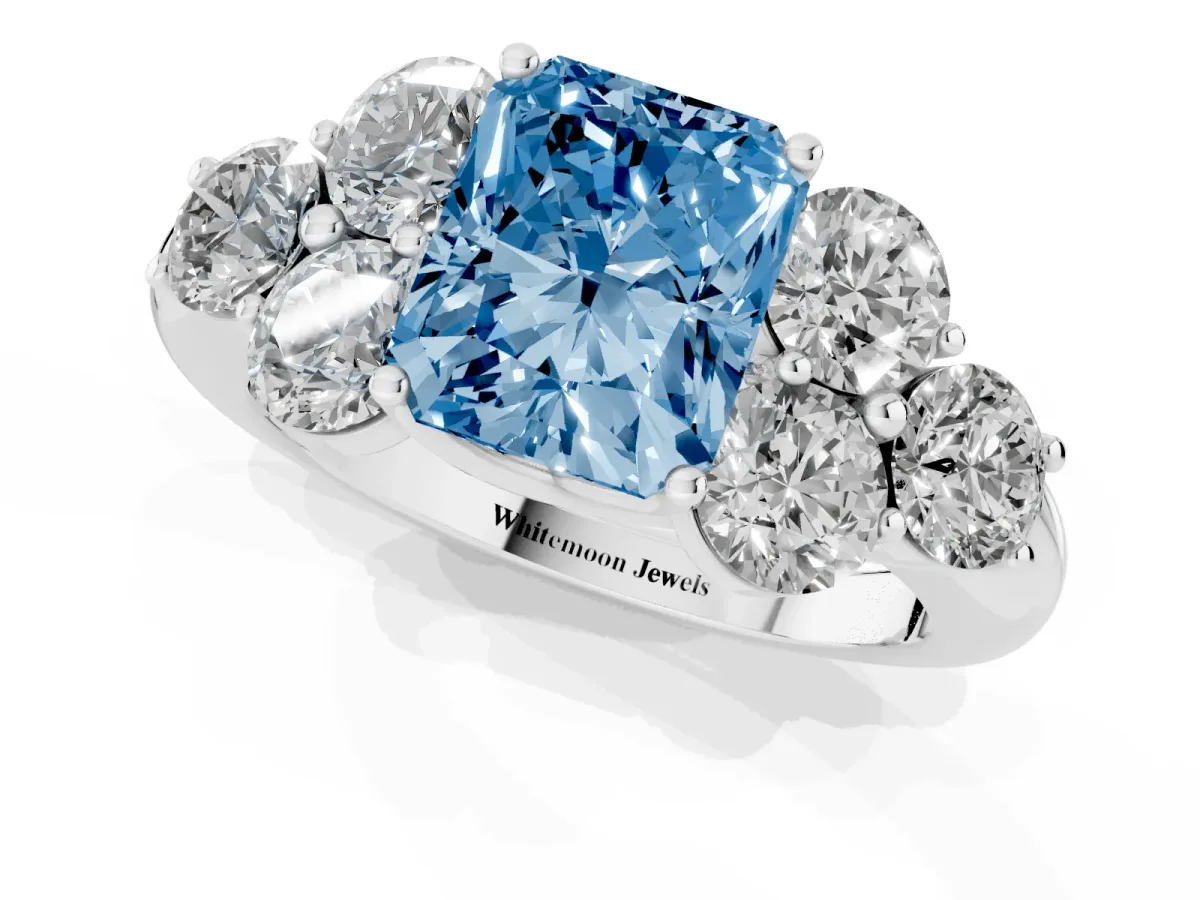 Fancy Blue Radiant Cut Cut Diamond Cluster Ring with Round Accent Stones and Prong Setting on a Classic Band White gold