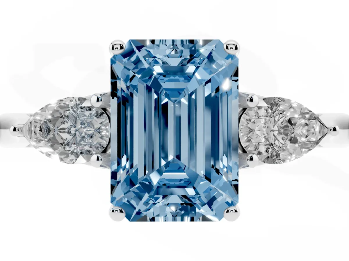 Fancy Blue Three-Stone Emerald Cut Brilliant Diamond Solitaire Ring with Tapered Band and Four-Prong Setting White gold