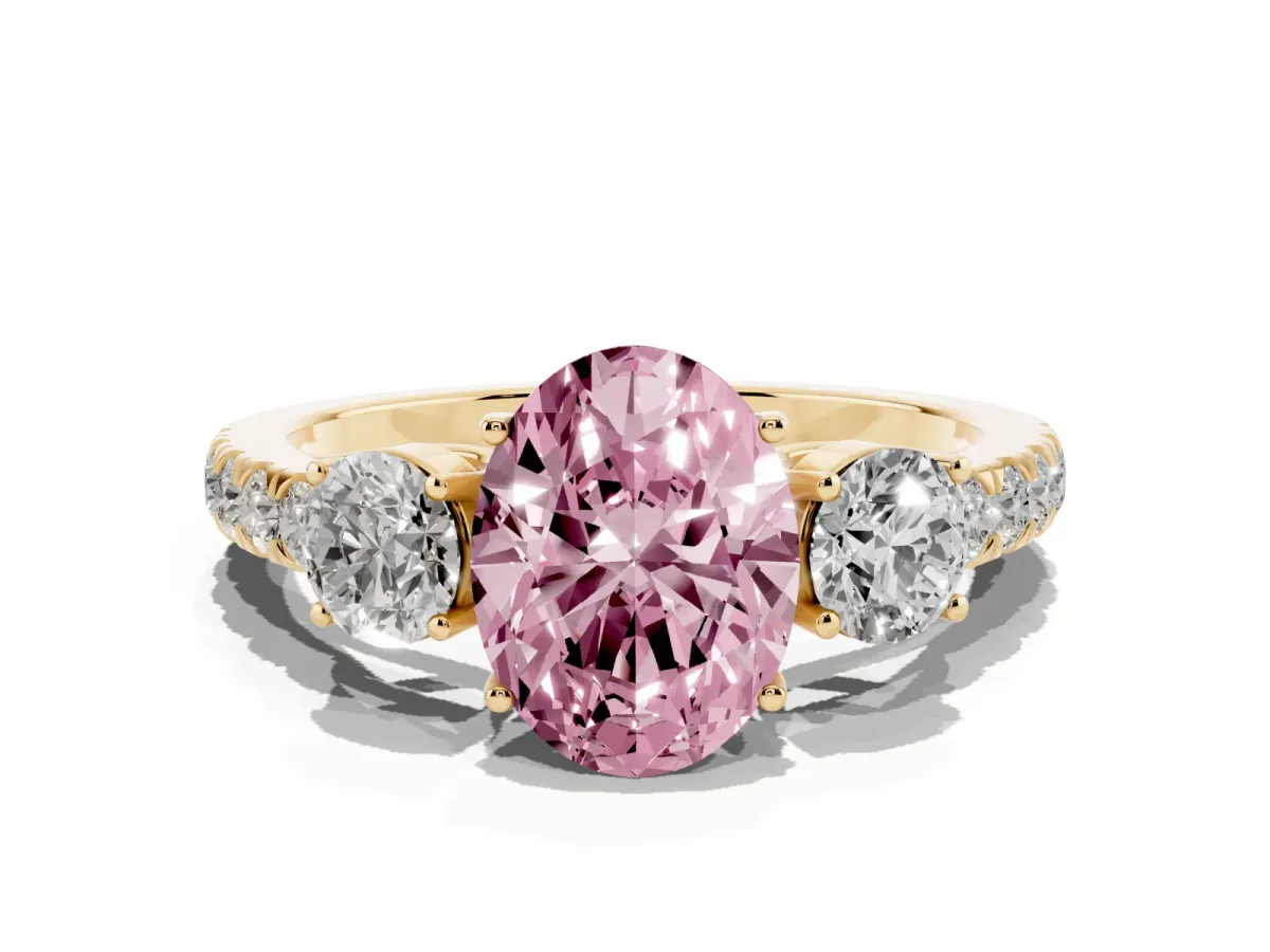 Fancy Pink Oval Cut Cut Diamond Three-Stone Ring with Round Side Stones and Pavé Band Yellow gold