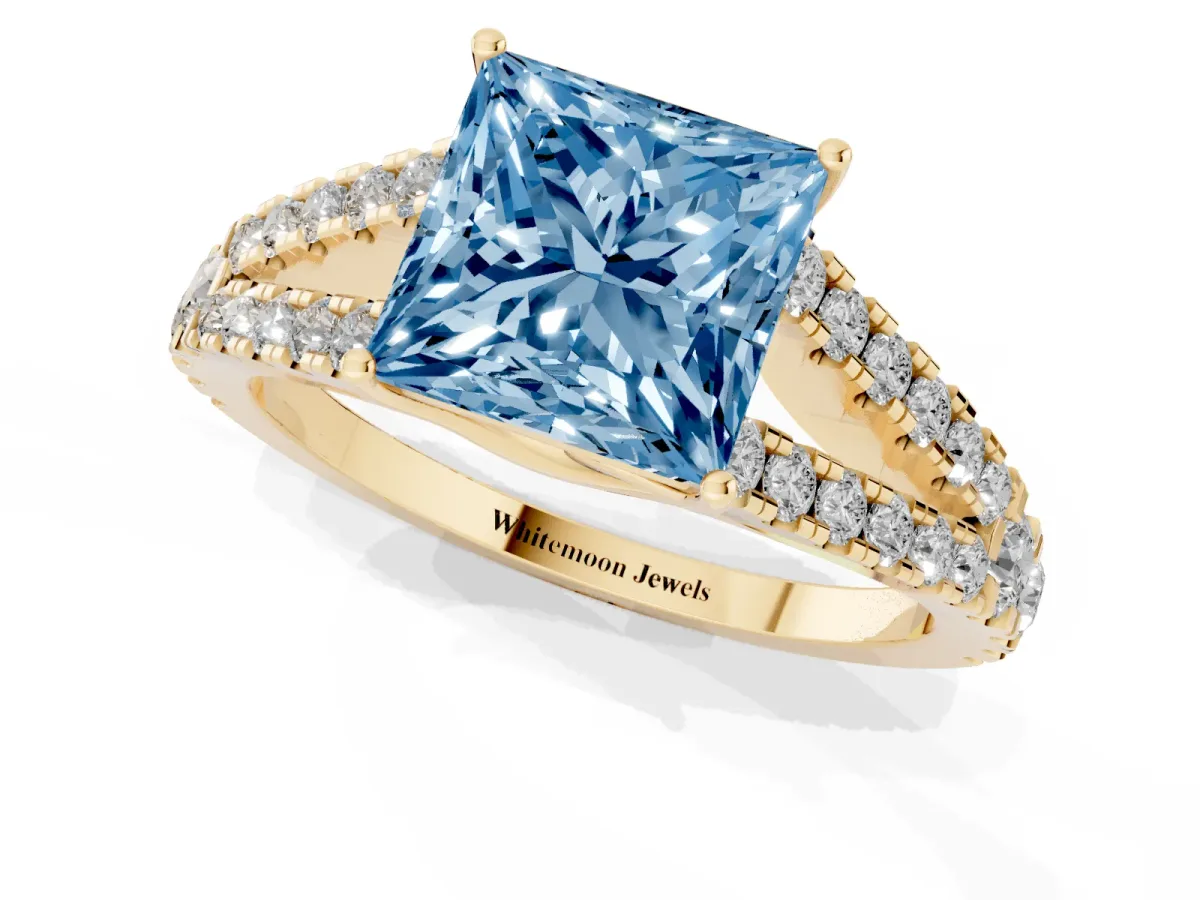 Fancy Blue Princess Cut Diamond Split Shank Engagement Ring with Round Pavé and Prong Setting Yellow gold