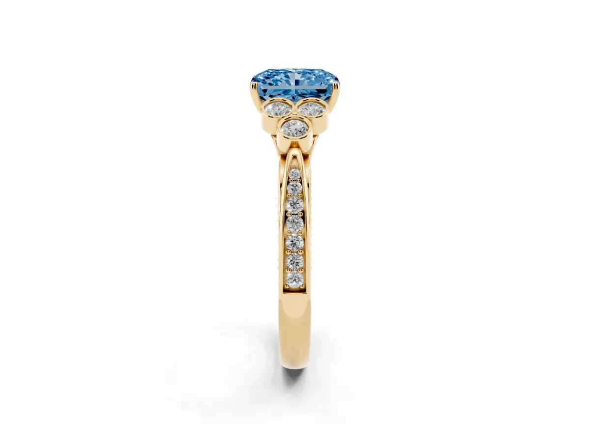 Fancy Blue Radiant Cut Cut Diamond Engagement Ring with Bezel Set Round Side Stones and Prong Setting Yellow gold