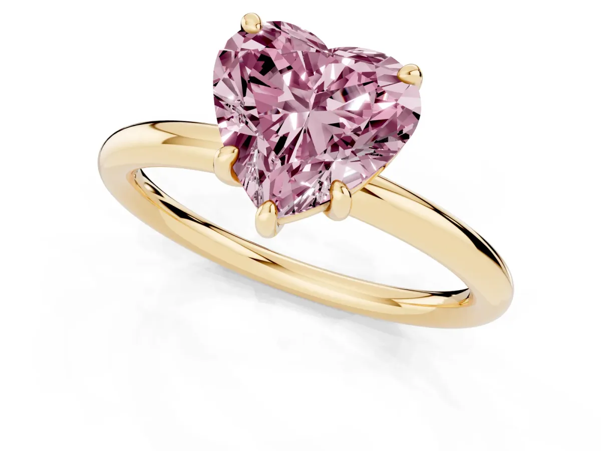 Fancy Pink Heart Cut Solitaire Diamond Ring with Four-Prong Setting on a Plain Band Yellow gold