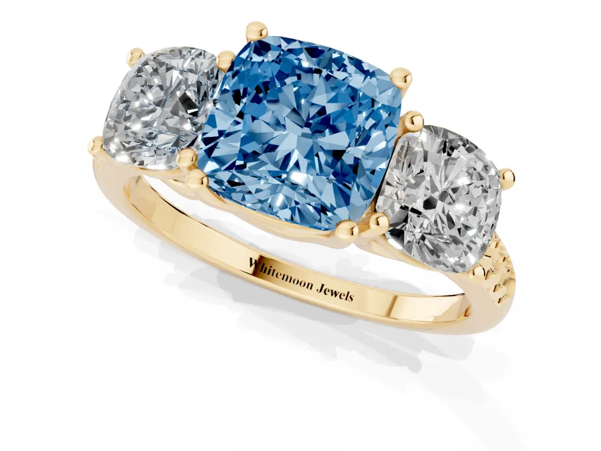 Fancy Blue Three-Stone Cushion Cut Diamond Ring with Round Pavé Band and Prong Setting Yellow gold