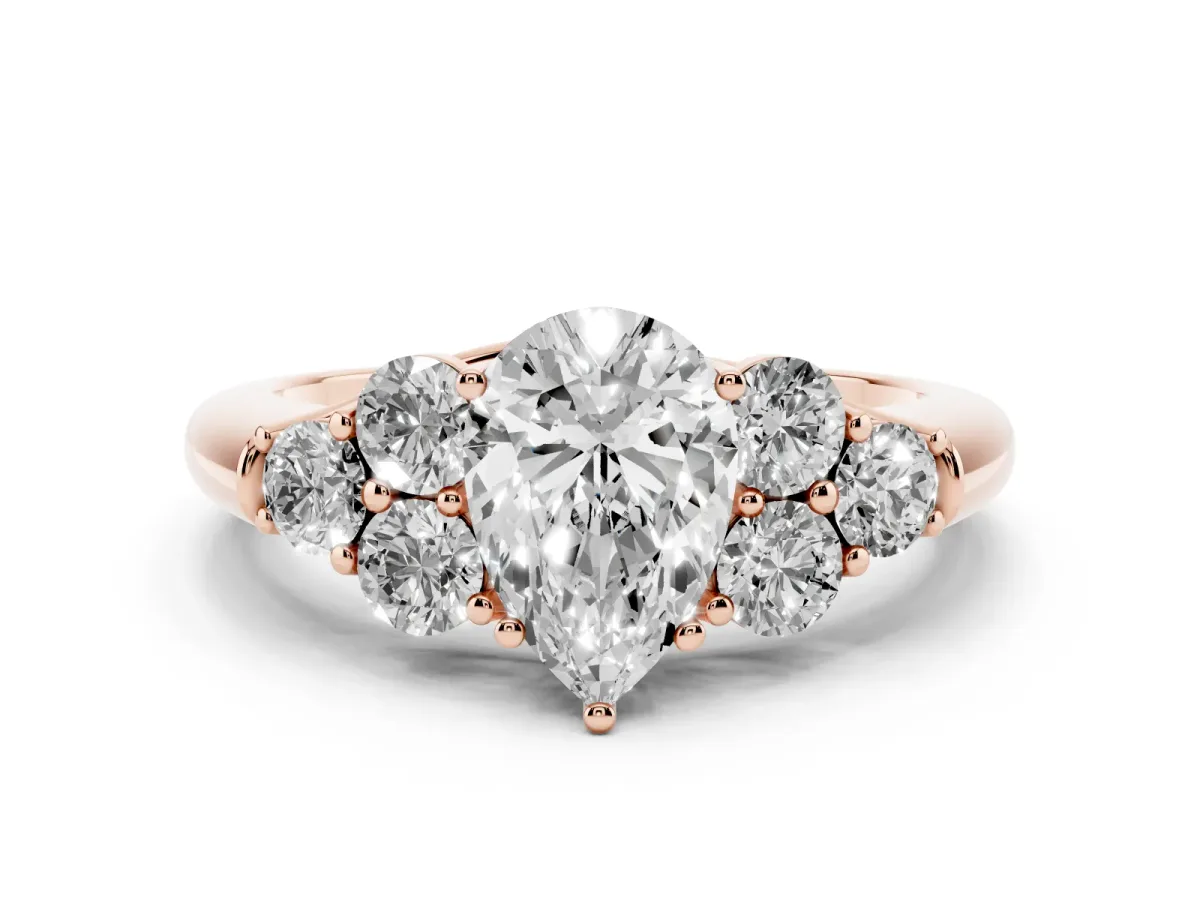 Pear Cut Cut Diamond Cluster Ring with Round Accent Stones and Prong Setting on a Classic Band Rose gold