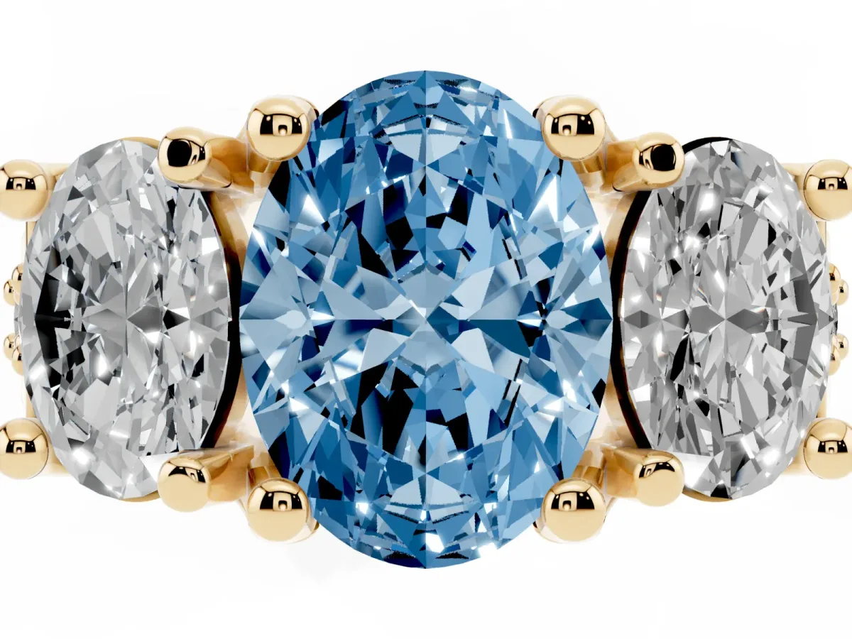Fancy Blue Oval Cut Diamond Three-Stone Ring with Channel Set Band and Four-Prong Setting Yellow gold