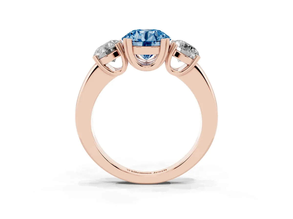 Fancy Blue Three-Stone Round Cut Cut Diamond Ring with Channel Set Band and Four-Prong Setting Rose gold