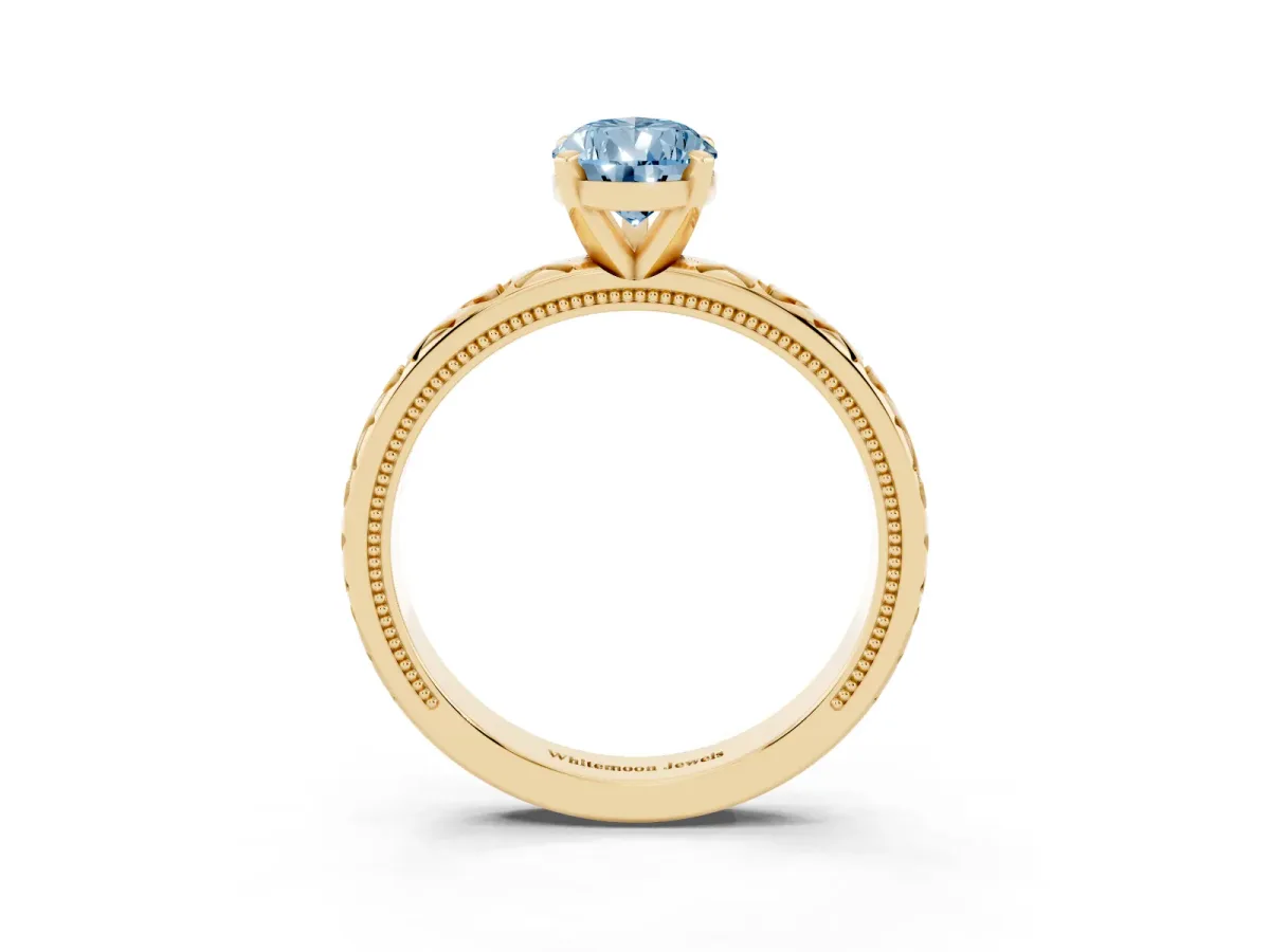 Fancy Blue Pear Cut Solitaire Diamond Engagement Ring with XO Engraved Band and Four-Prong Setting Yellow gold