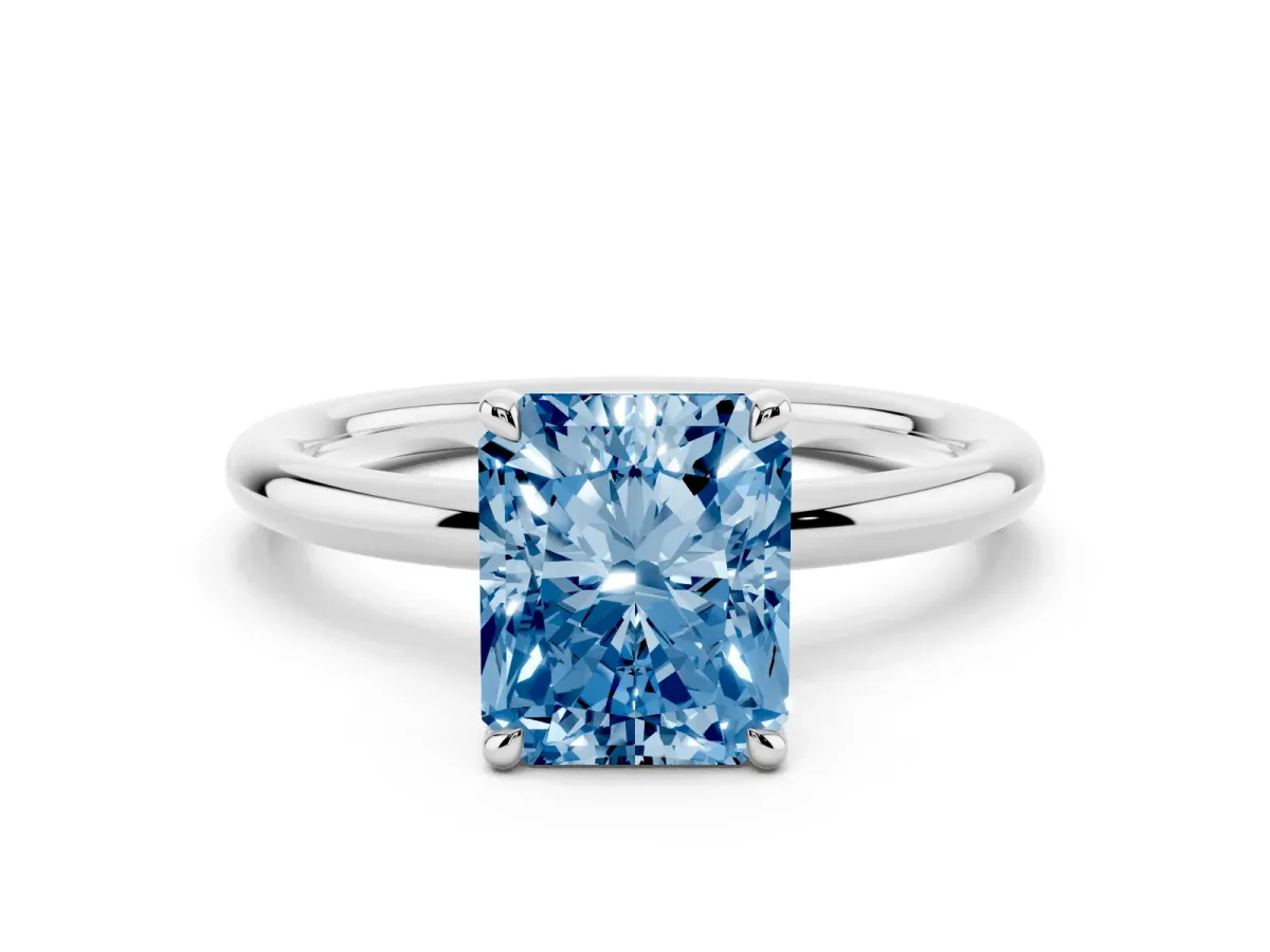 Fancy Blue Radiant Cut Diamond Solitaire Ring with Thin Band and Four-Prong Setting Silver