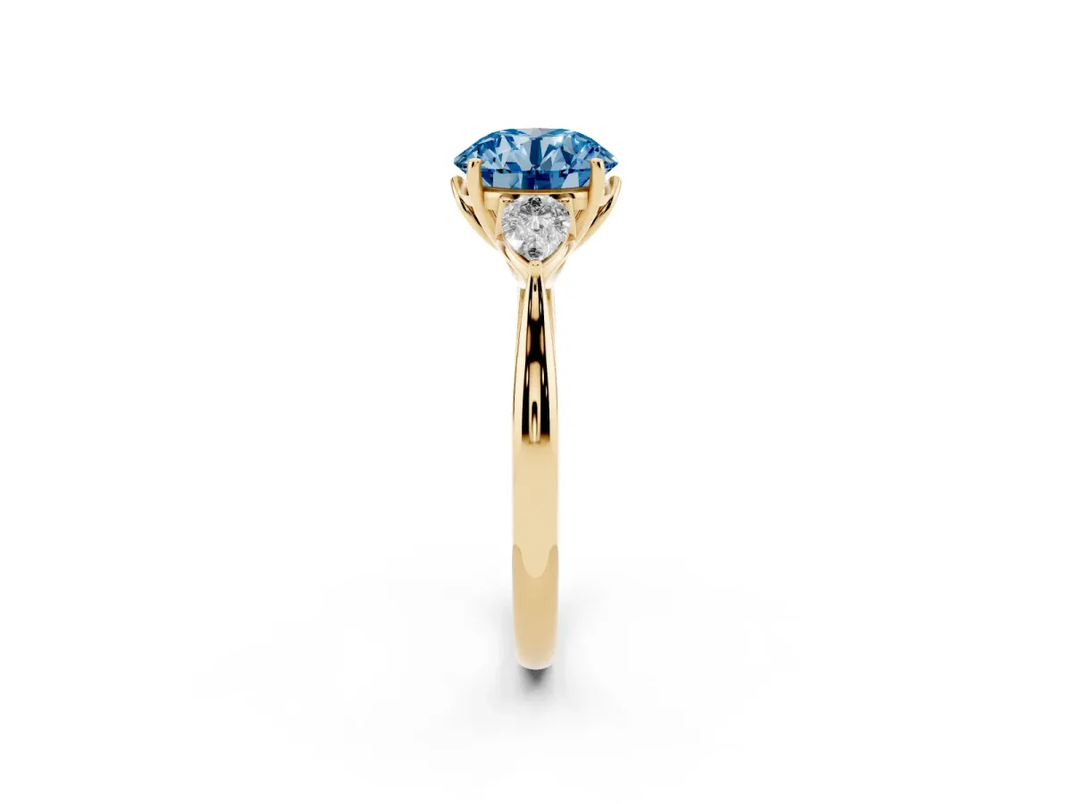 Fancy Blue Three-Stone Round Cut Brilliant Diamond Solitaire Ring with Tapered Band and Four-Prong Setting Yellow gold