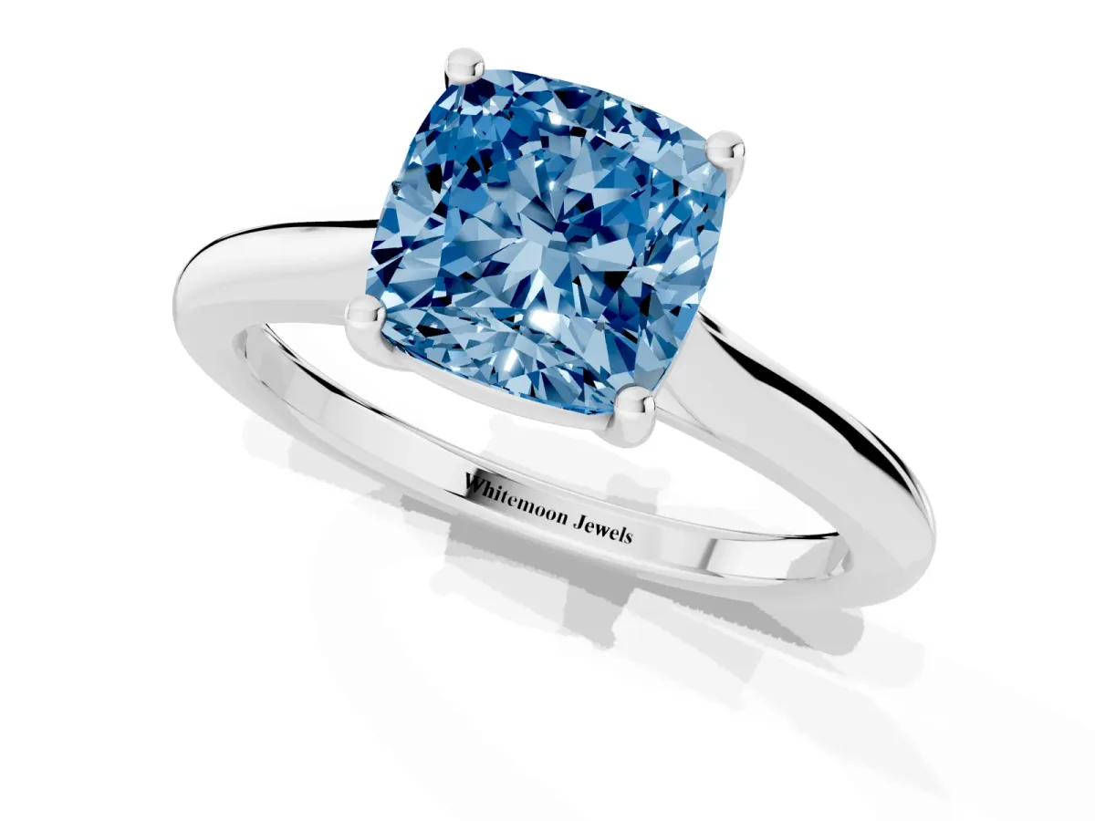 Fancy Blue Cushion Cut Cut Solitaire Ring with Cathedral Band and Four-Prong Setting Silver