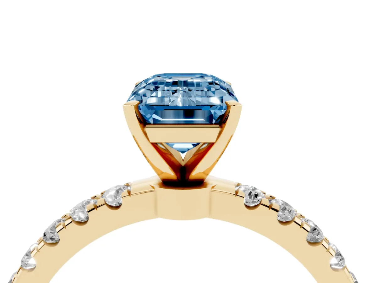 Fancy Blue Emerald Cut Diamond Solitaire Ring with Pavé Accents and Four-Prong Setting Yellow gold