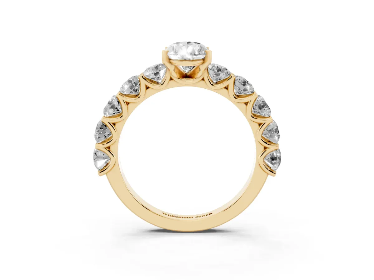 Pear Cut Diamond Prong Setting with Side Stones on a Pave Band Yellow gold