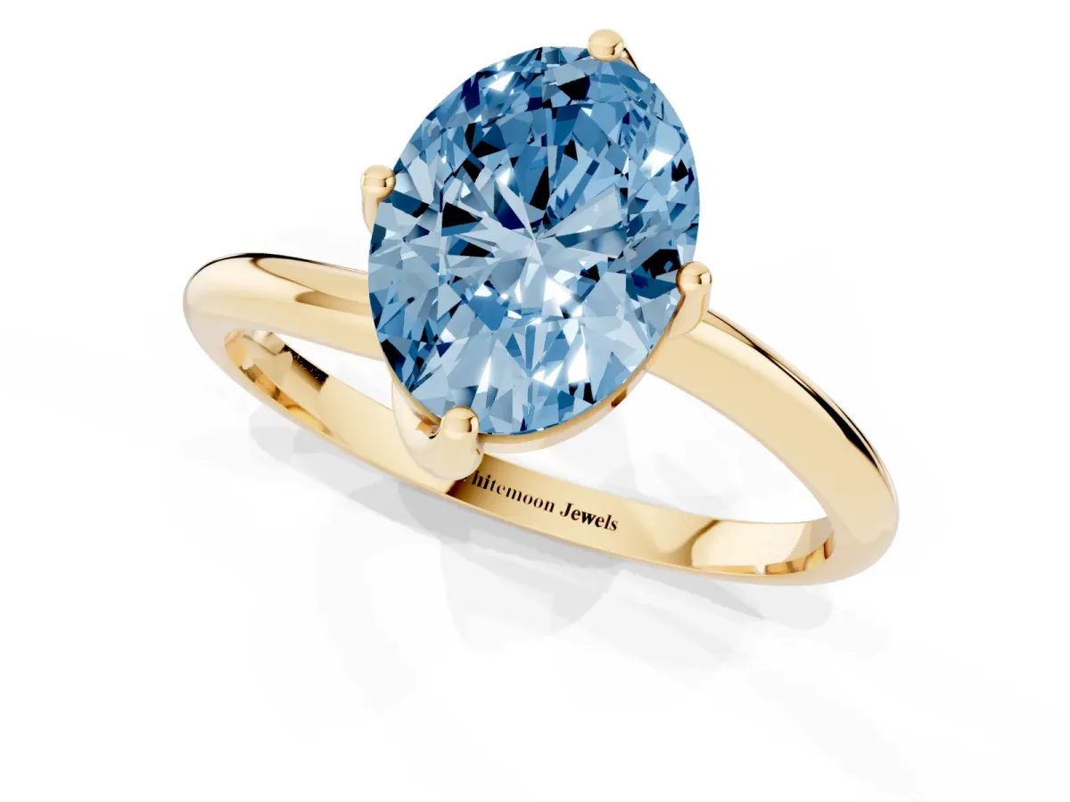 Fancy Blue Oval Cut Diamond Solitaire Engagement Ring with Four-Prong Setting and Classic Band Yellow gold