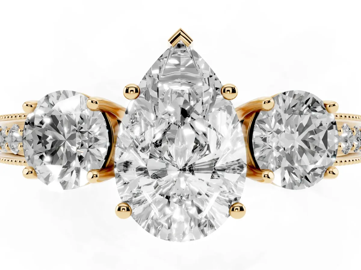 Pear Cut Three-Stone Diamond Ring with Pavé Band and Four-Prong Setting Yellow gold