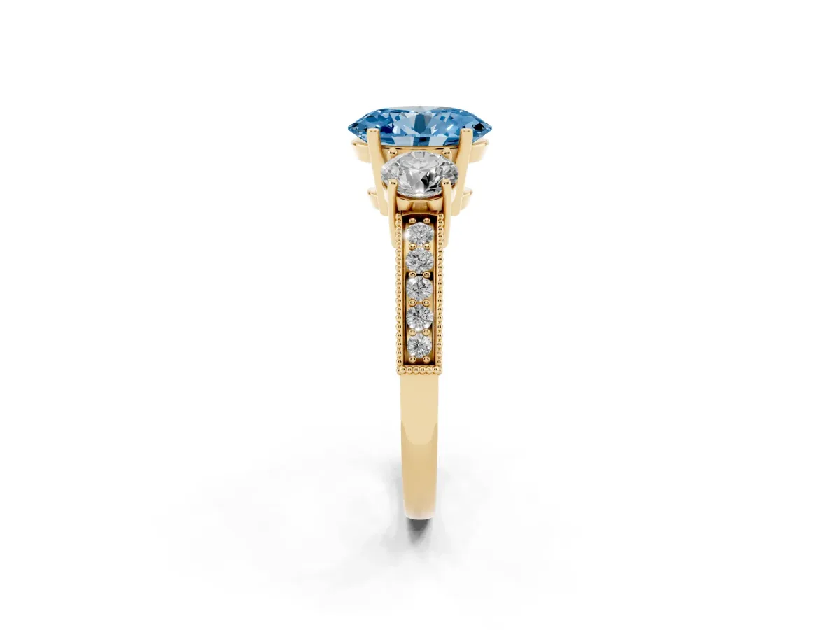 Fancy Blue Oval Cut Three-Stone Diamond Ring with Pavé Band and Four-Prong Setting Yellow gold