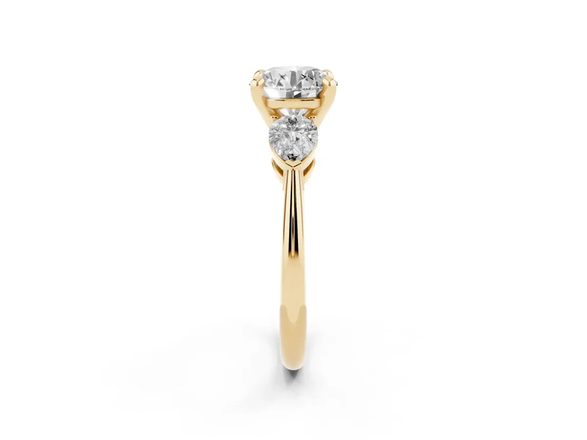 Three-Stone Round Cut Diamond Ring with Pear Side Stones and Four-Prong Setting Yellow gold