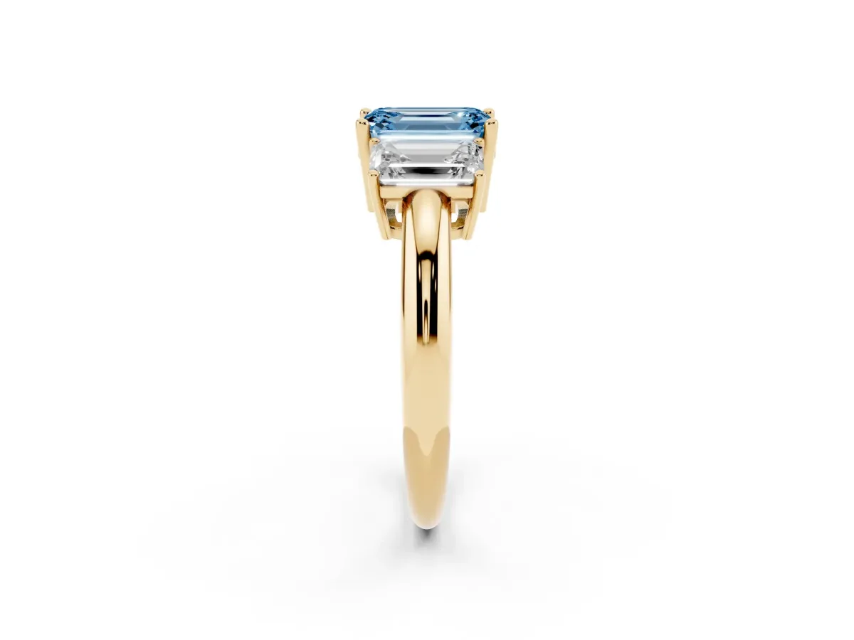 Fancy Blue Three-Stone Emerald Cut Cut Diamond Engagement Ring with Prong Setting on a White Gold Band Yellow gold