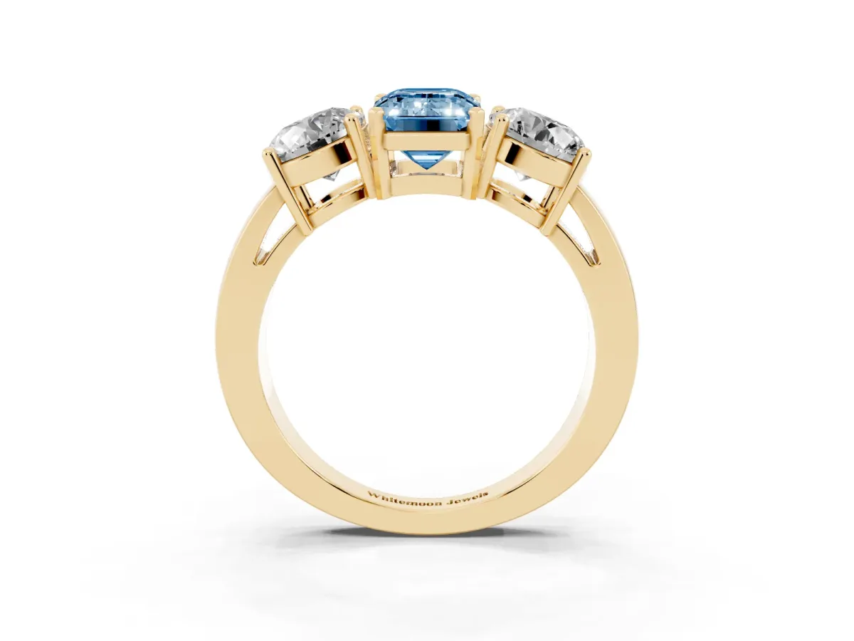 Fancy Blue Three-Stone Emerald Cut Diamond Ring with Round Side Stones, Classic Band, and Four-Prong Setting Yellow gold