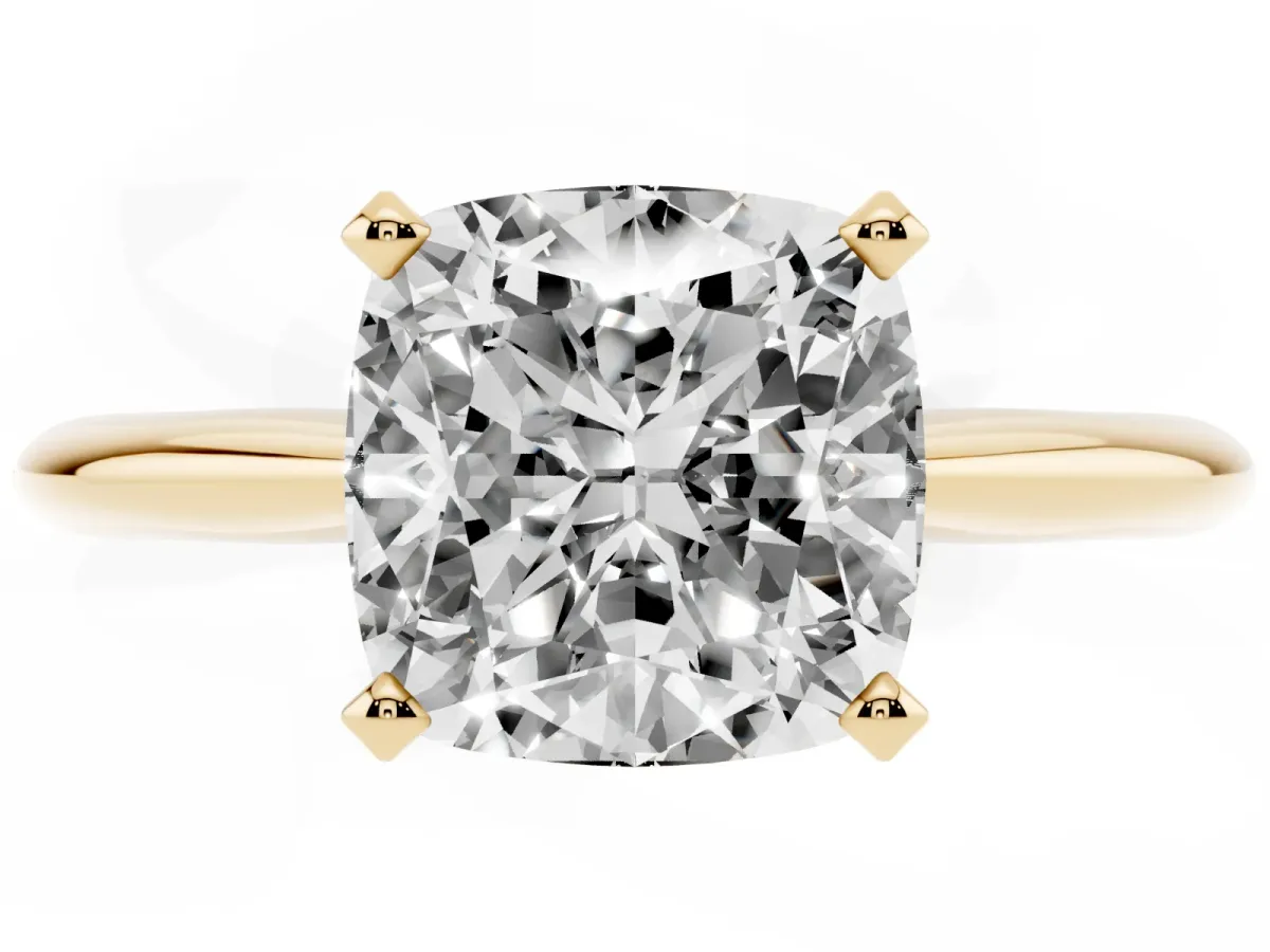 Cushion Cut Cut Solitaire Ring with Four-Prong Setting on a Classic Band Yellow gold
