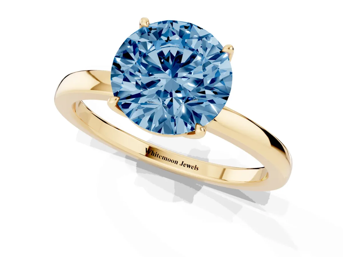 Fancy Blue Round Cut Diamond Solitaire Ring with Thin Band and Prong Setting Yellow gold