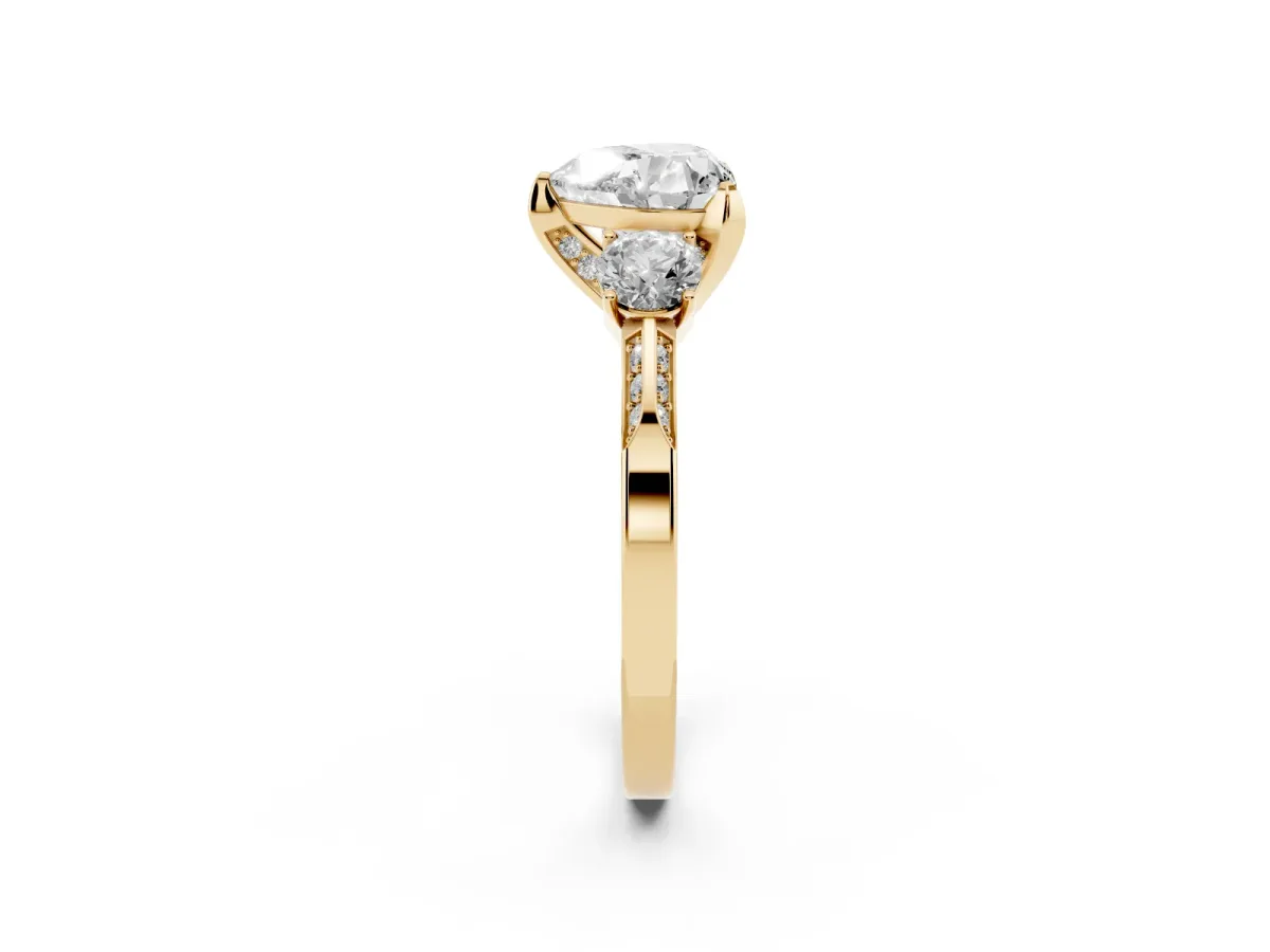 Heart Cut Brilliant Three-Stone Diamond Ring with Pavé Band and Four-Prong Setting Yellow gold