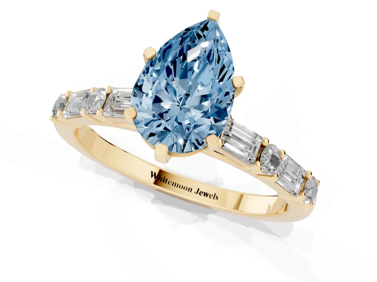 Fancy Blue Pear Cut Diamond Solitaire with Side Baguettes and Channel Set Band Yellow gold