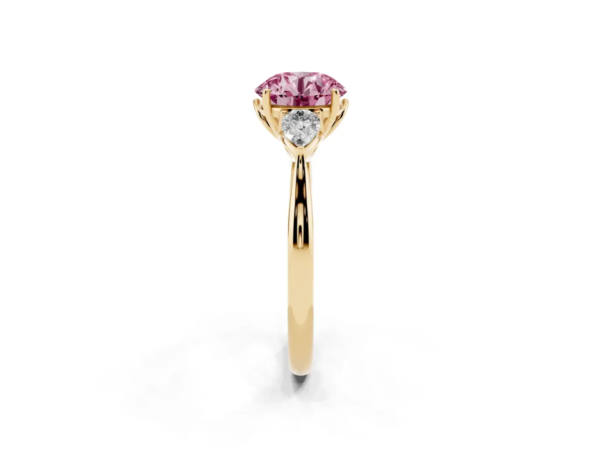 Fancy Pink Three-Stone Round Cut Diamond Ring with Pear Side Stones in Four-Prong Setting Yellow gold