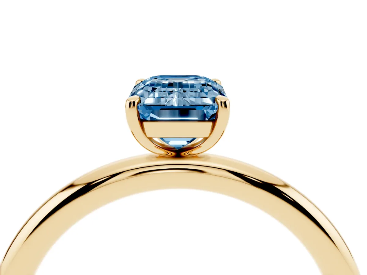 Fancy Blue Emerald Cut Solitaire Diamond Ring with Four-Prong Setting on a Plain Band Yellow gold