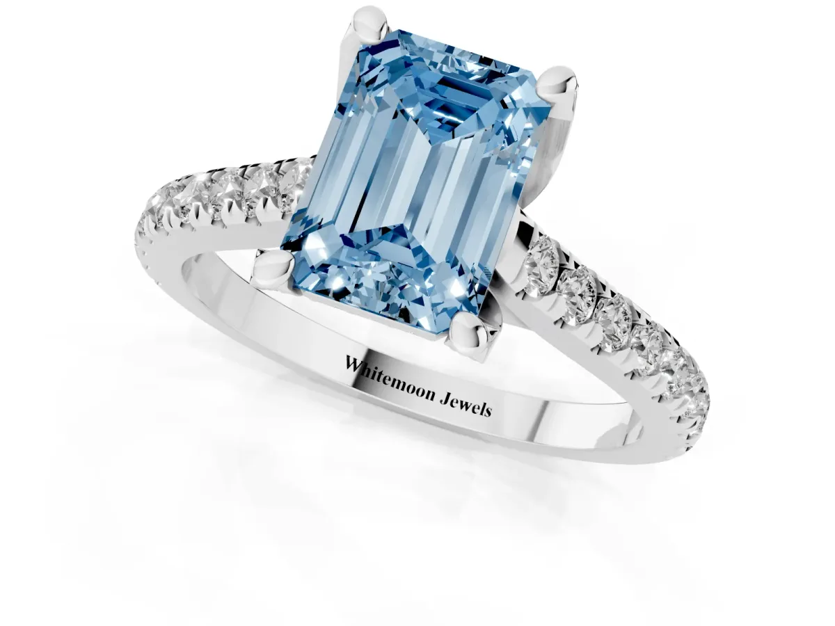 Fancy Blue Emerald Cut Brilliant Diamond Solitaire with Pavé Band and Four-Prong Setting Platinum