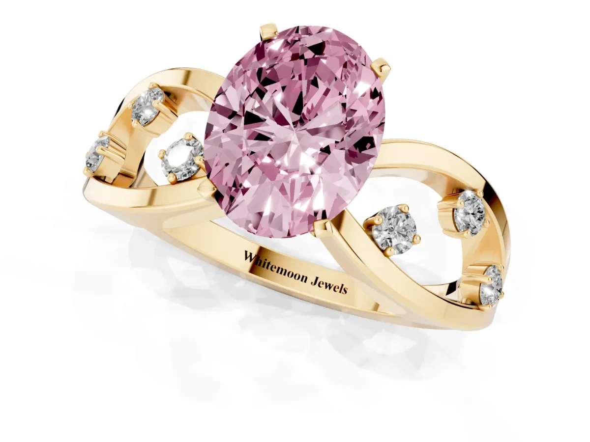 Fancy Pink Oval Cut Cut Solitaire Diamond with Side Stones on Criss-Cross Band and Four-Prong Setting Yellow gold