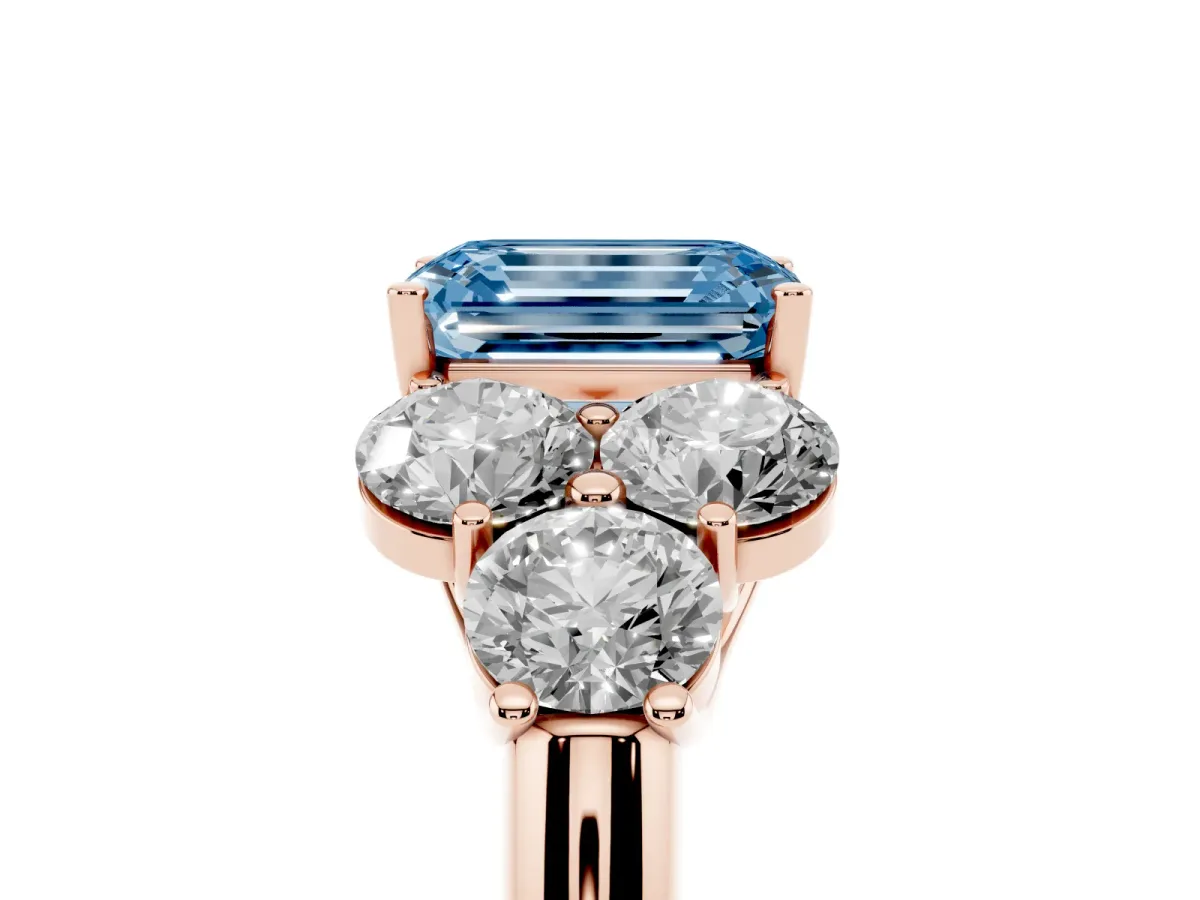 Fancy Blue Emerald Cut Cut Diamond Cluster Ring with Round Accent Stones and Prong Setting on a Classic Band Rose gold