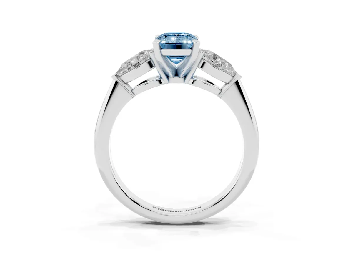 Fancy Blue Three-Stone Emerald Cut Diamond Ring with Pear Side Stones and Four-Prong Setting Platinum