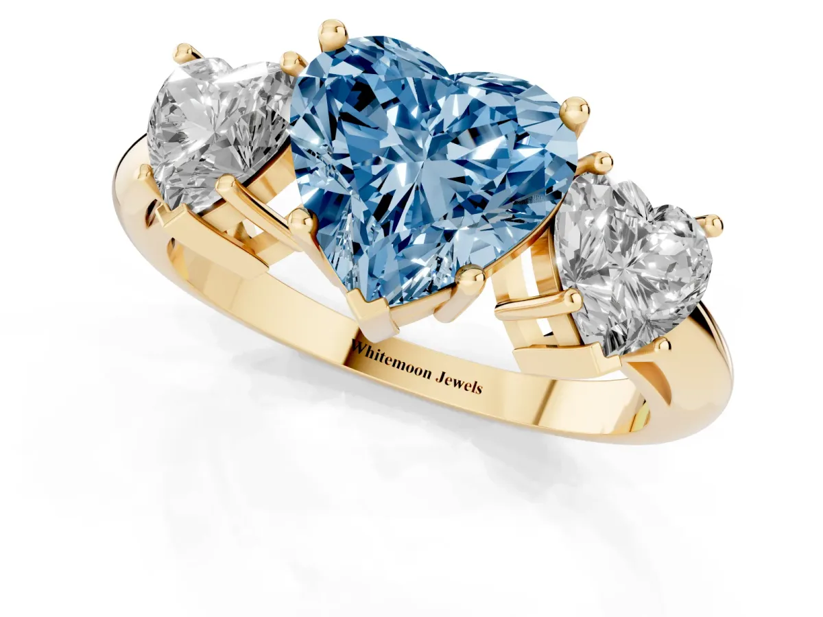Fancy Blue Three-Stone Heart Cut Cut Diamond Engagement Ring with Prong Setting on a White Gold Band Yellow gold