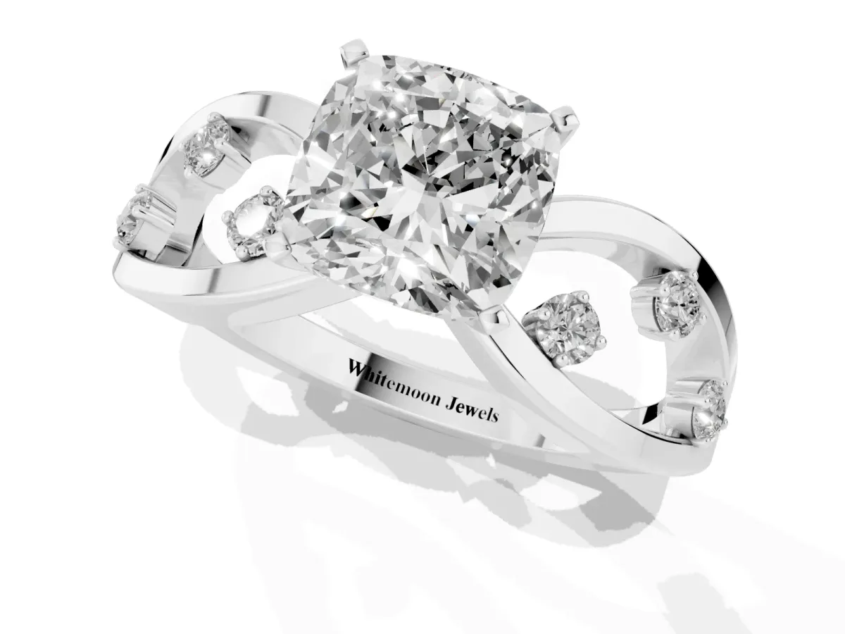 Cushion Cut Cut Solitaire Diamond with Side Stones on Criss-Cross Band and Four-Prong Setting Silver