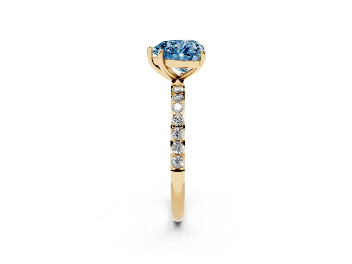 Fancy Blue Heart Cut Diamond Solitaire Ring with Round Pavé Shoulders and Prong Setting Yellow gold
