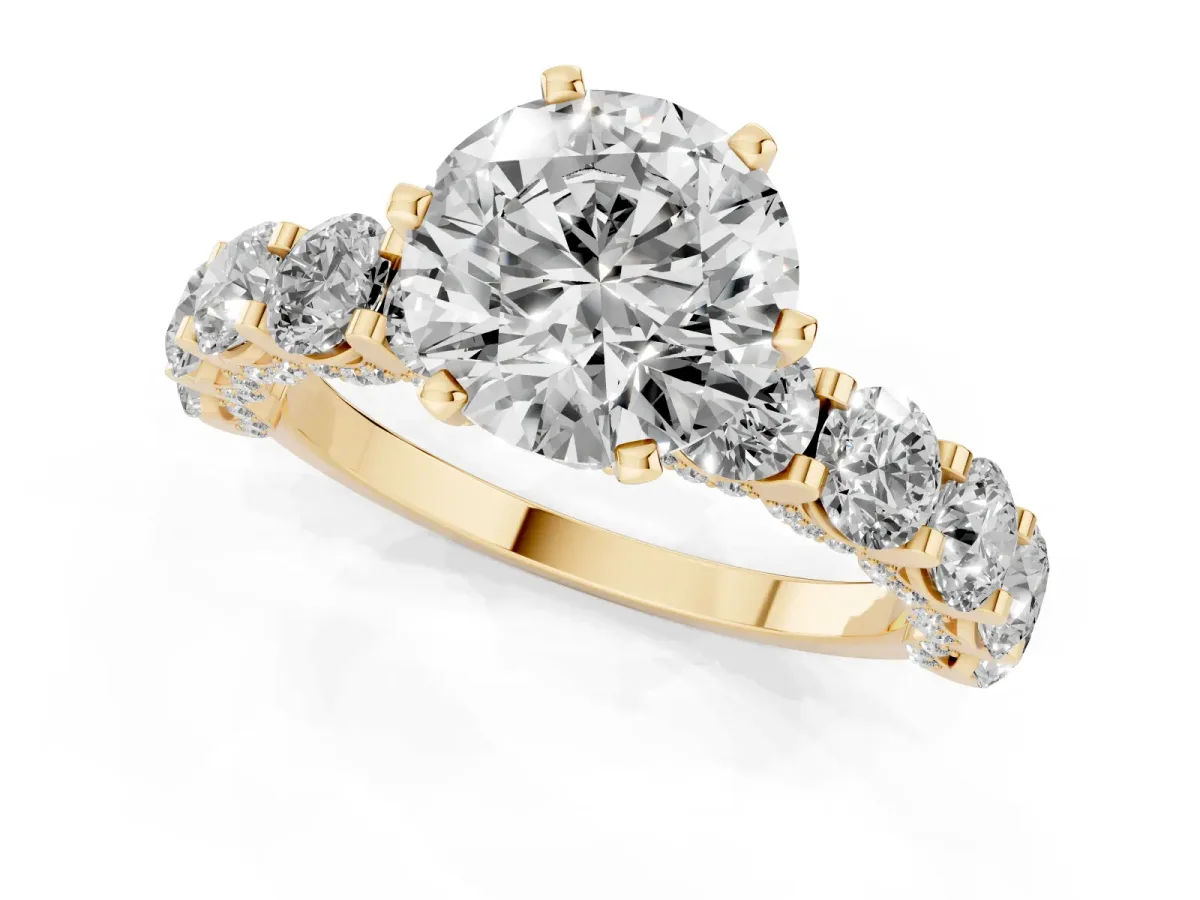 Round Cut Diamond Side Stone Engagement Ring with Four-Prong Setting Yellow gold