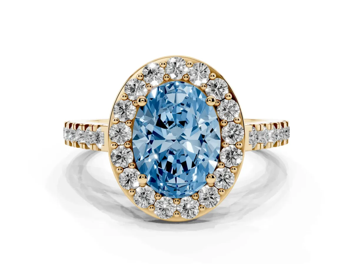 Fancy Blue Oval Cut Diamond Halo Ring with Round Pavé Split Shank and Prong Setting Yellow gold