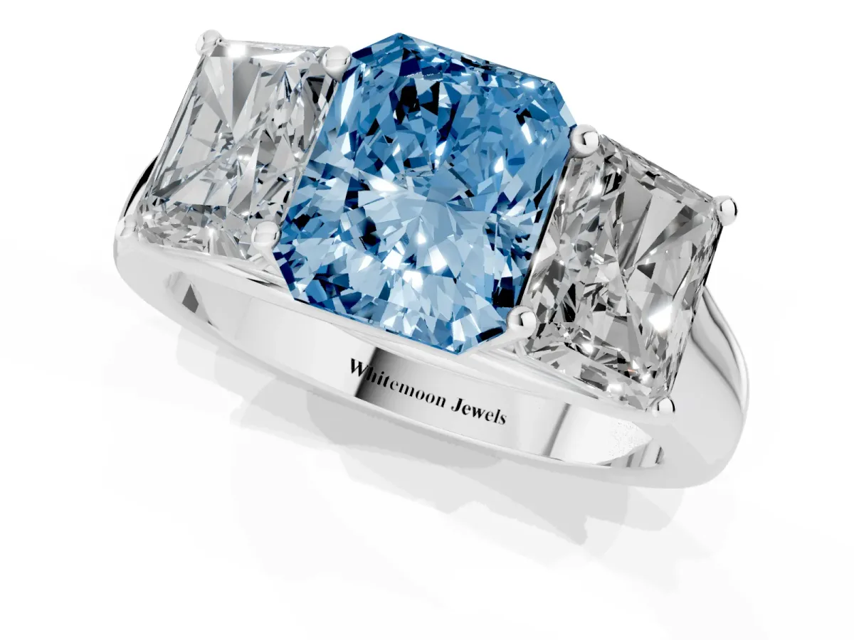 Fancy Blue Radiant Cut Three-Stone Diamond Ring with Prong Setting on a Classic Band Platinum