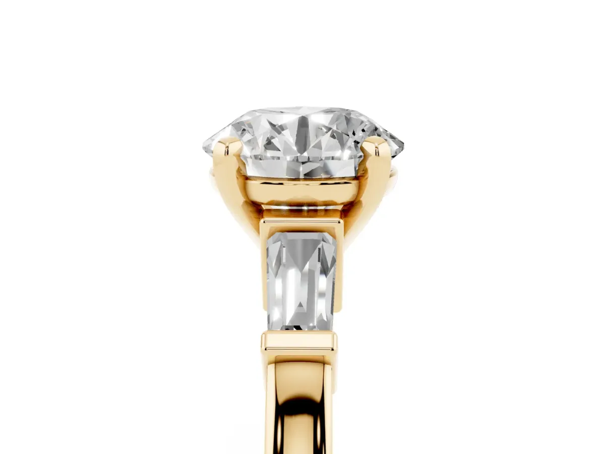 Round Cut Cut Diamond Solitaire Ring with Tapered Baguette Accents and Four-Prong Setting Yellow gold