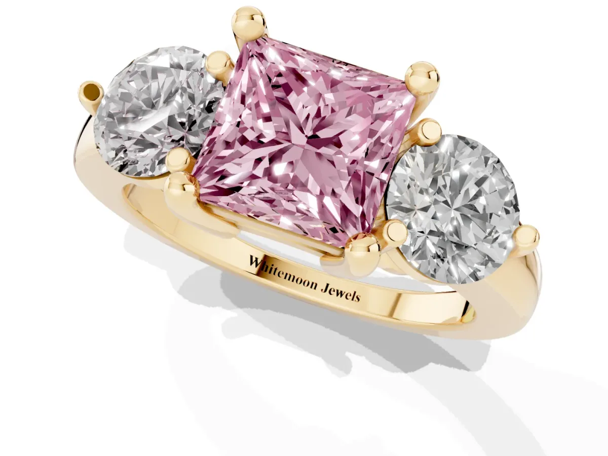 Fancy Pink Three-Stone Princess Cut Brilliant Cut Solitaire Ring with Prong Setting on a Classic Band Yellow gold