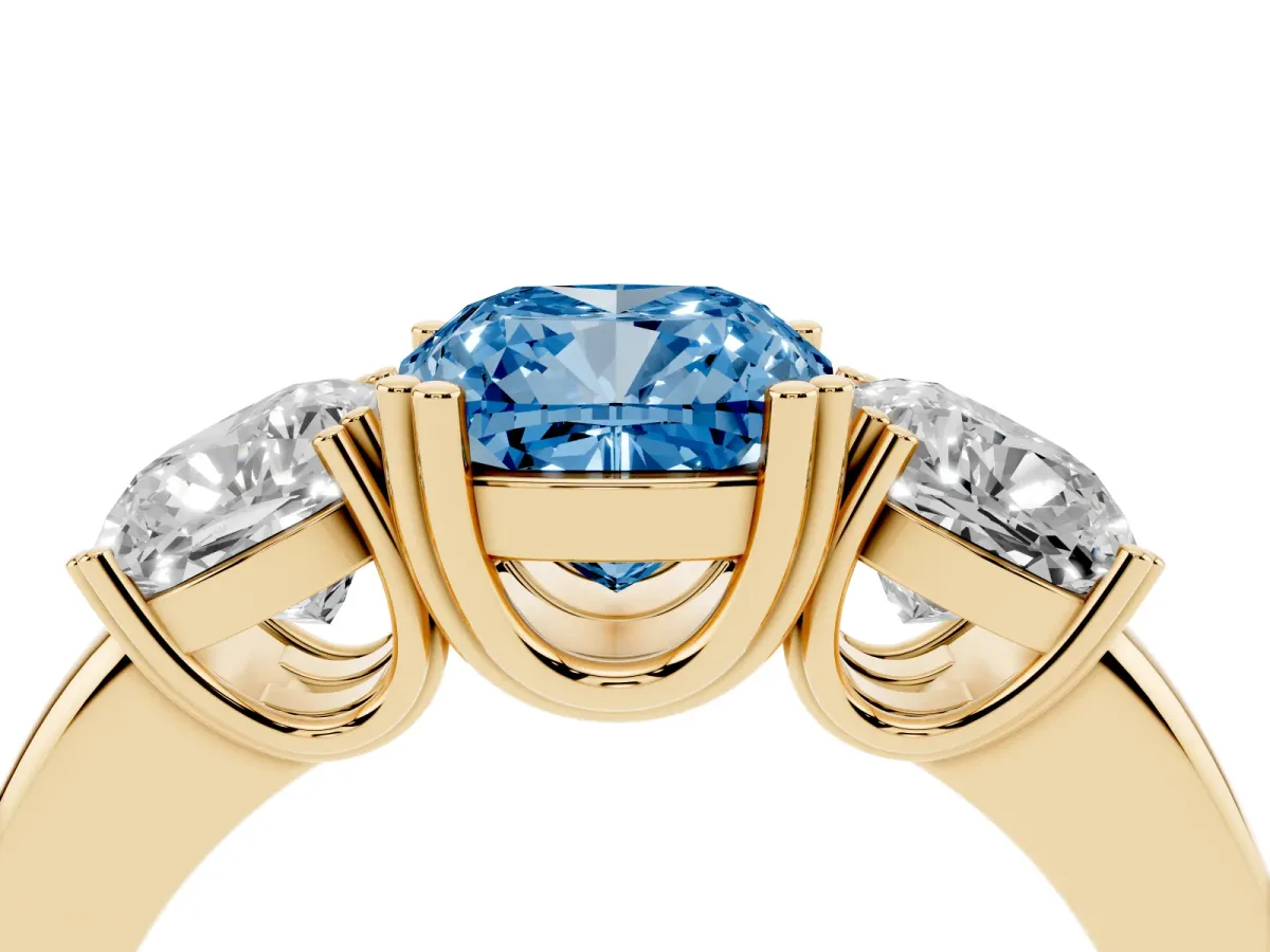 Fancy Blue Three-Stone Cushion Cut Cut Diamond Ring with Channel Set Band and Four-Prong Setting Yellow gold