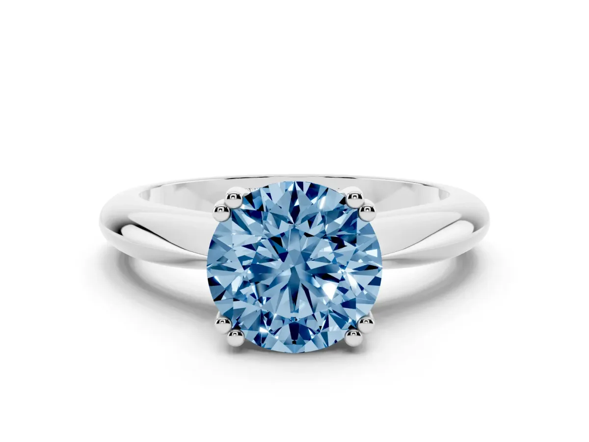 Fancy Blue Round Cut Cut Solitaire Engagement Ring with Tapered Band and Four-Prong Setting Silver