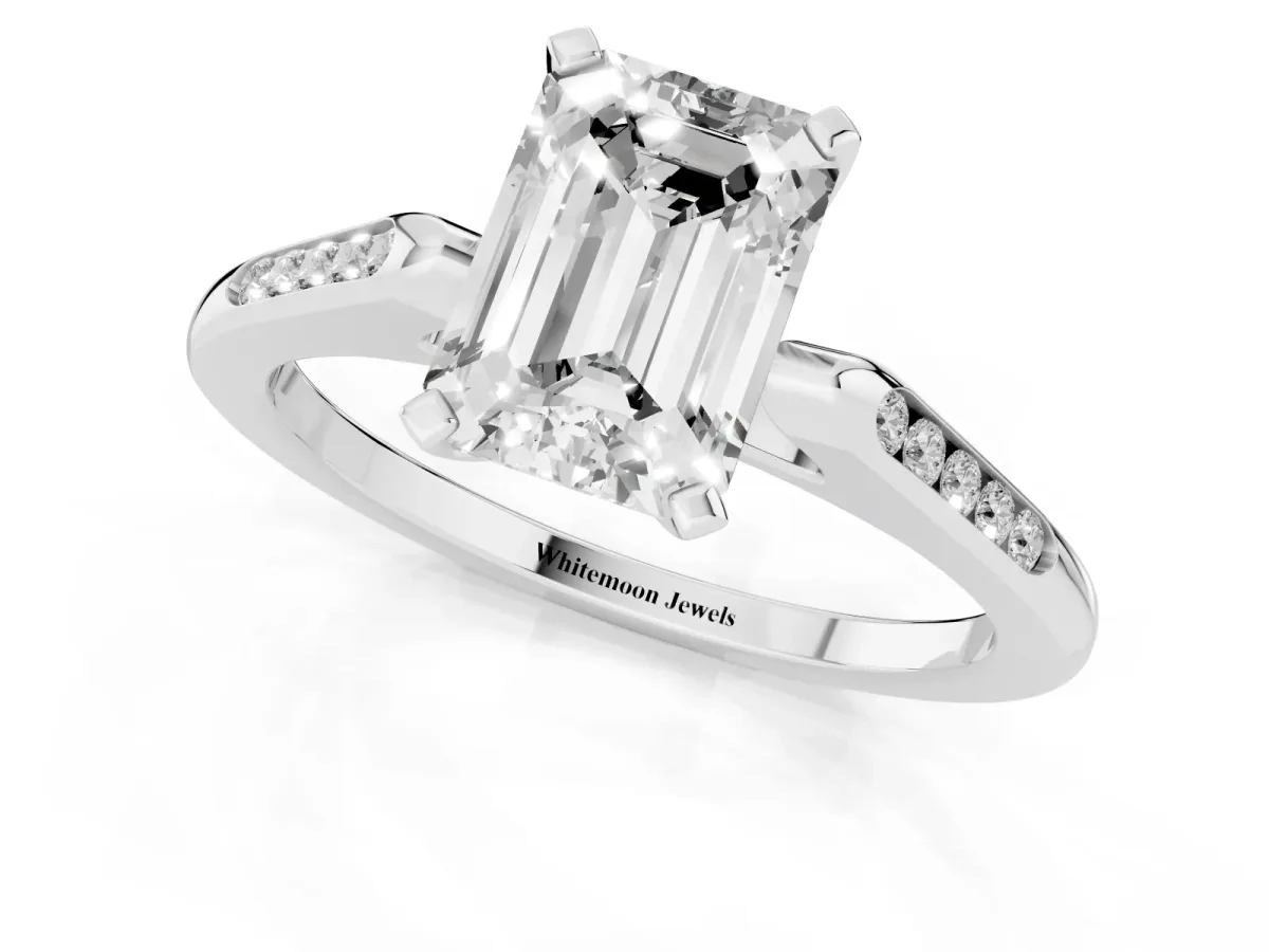 Emerald Cut Diamond Solitaire Ring with Channel Set Round Band and Prong Setting White gold