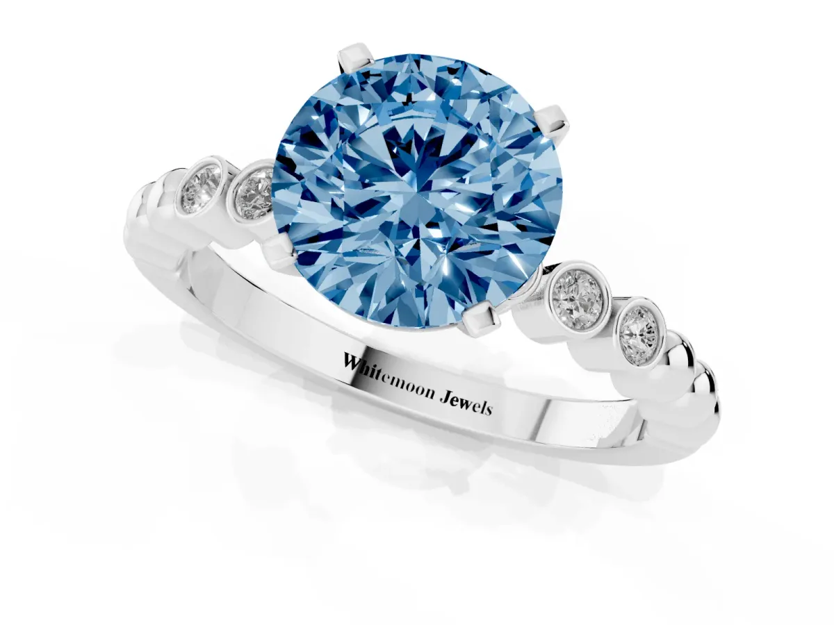 Fancy Blue Round Cut Solitaire Bezel Accent Diamond Engagement Ring with Beaded Band and Four-Prong Setting Silver