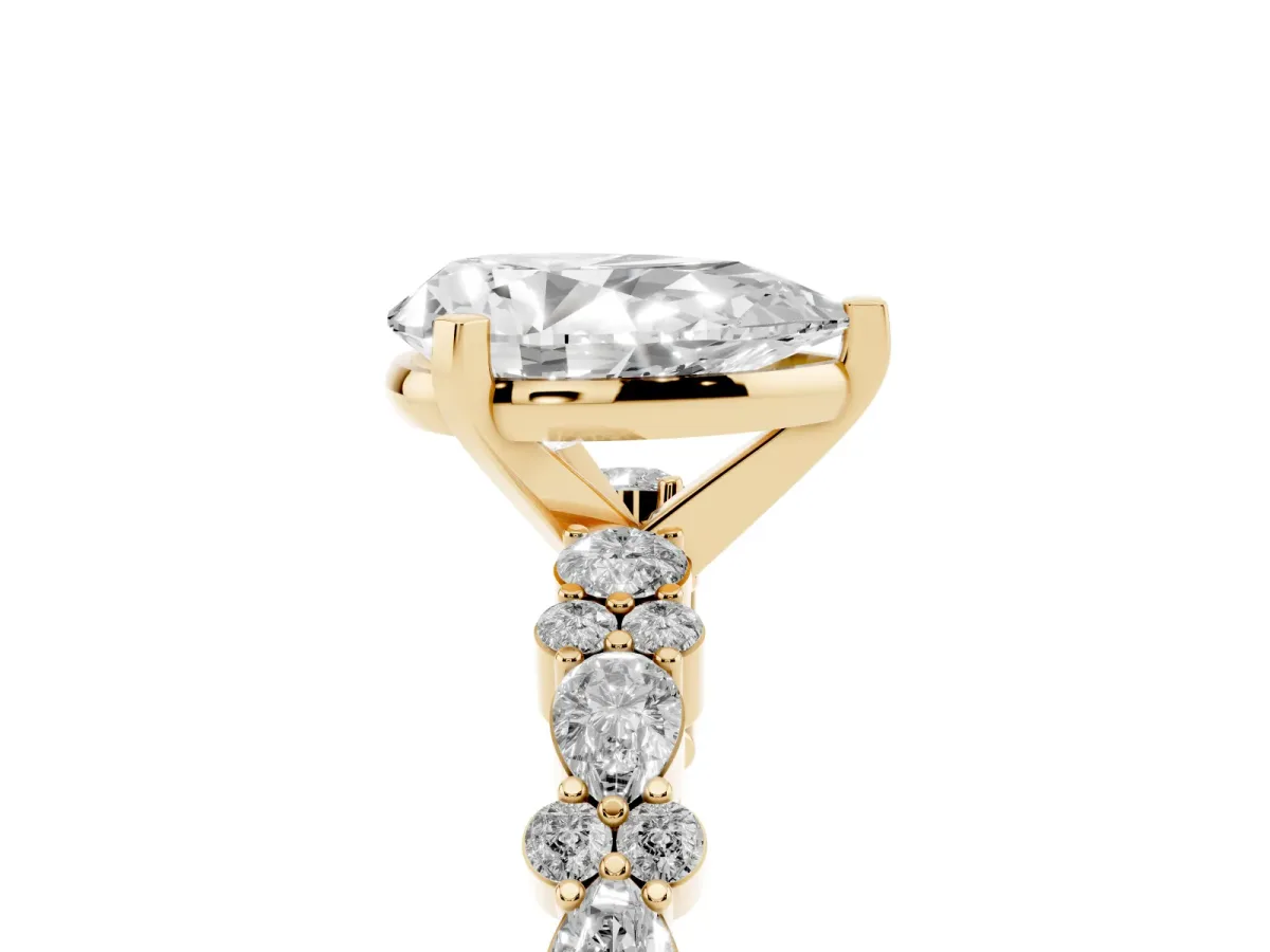 Pear Cut Diamond Side Stone Solitaire Ring with Round and Four-Prong Setting Yellow gold