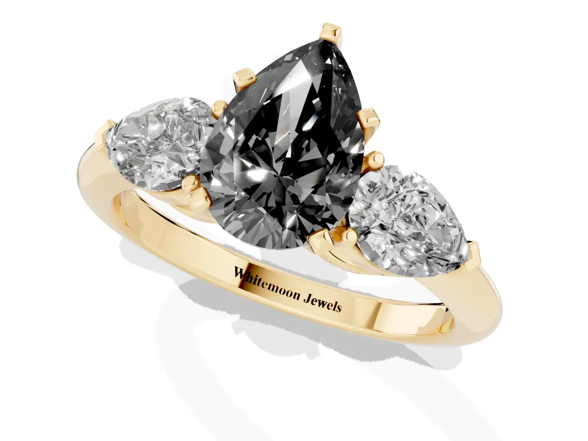 Fancy Black Three-Stone Pear Cut Diamond Ring with Pear Side Stones and Four-Prong Setting Yellow gold