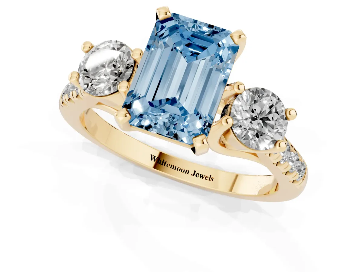 Fancy Blue Three-Stone Emerald Cut Diamond Pavé Band with Four-Prong Setting Yellow gold
