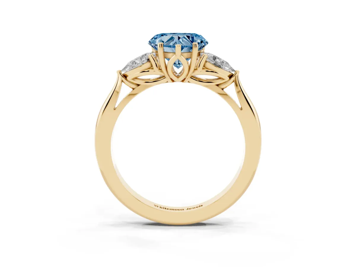 Fancy Blue Three-Stone Heart Cut Diamond Ring with Pear Side Stones in Four-Prong Setting Yellow gold
