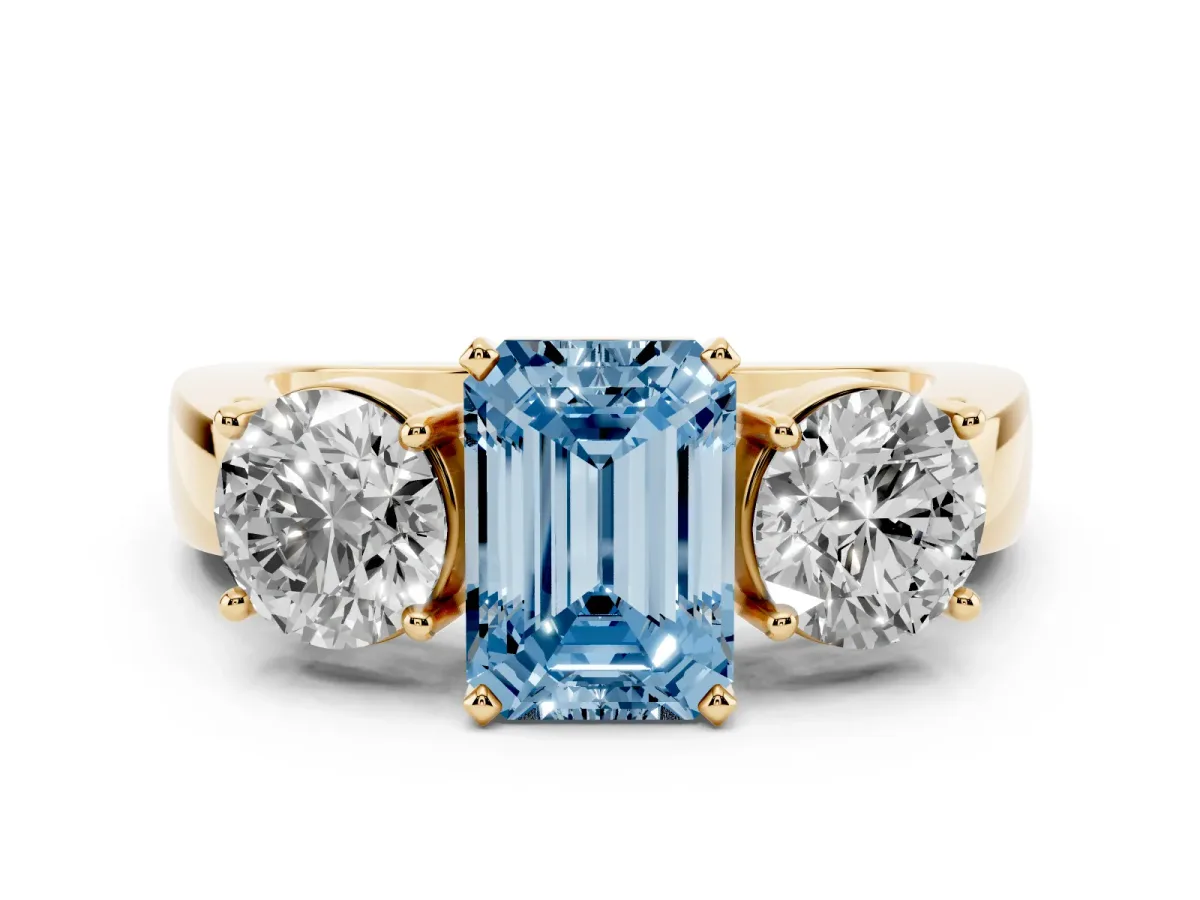 Fancy Blue Three-Stone Emerald Cut Diamond Ring with Round Side Stones, Classic Band, and Four-Prong Setting Yellow gold