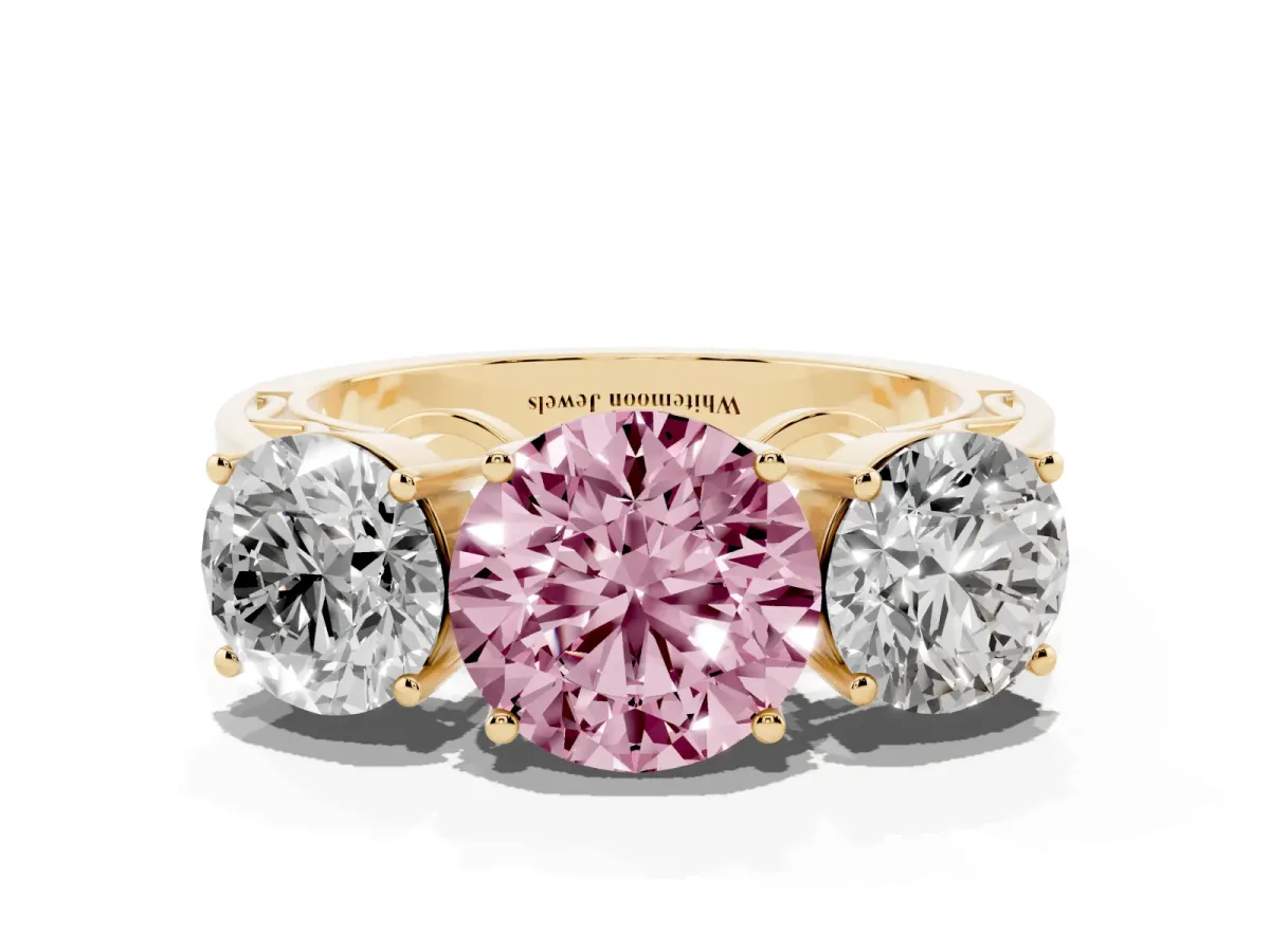Fancy Pink Round Cut Diamond Three-Stone Ring with Prong Setting and Textured Band Yellow gold